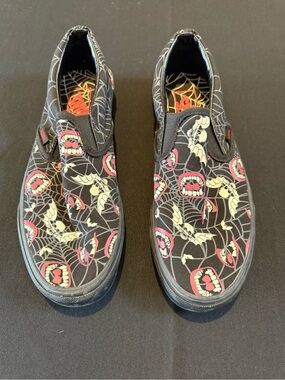 Vans Black Slip-On Sneakers with Spiderweb Insole and Red Bat Accents